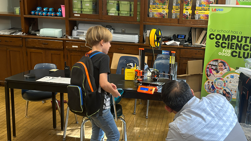A student and teacher at Virgil Middle School pictured with a 3D printer donated by the UCLA Samueli Makerspace