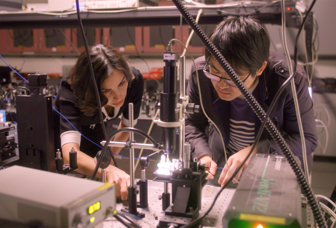 Professor Mona Jarrahi (left) working with her doctoral student Yifan Zhao (right) on the terahertz photonic chip